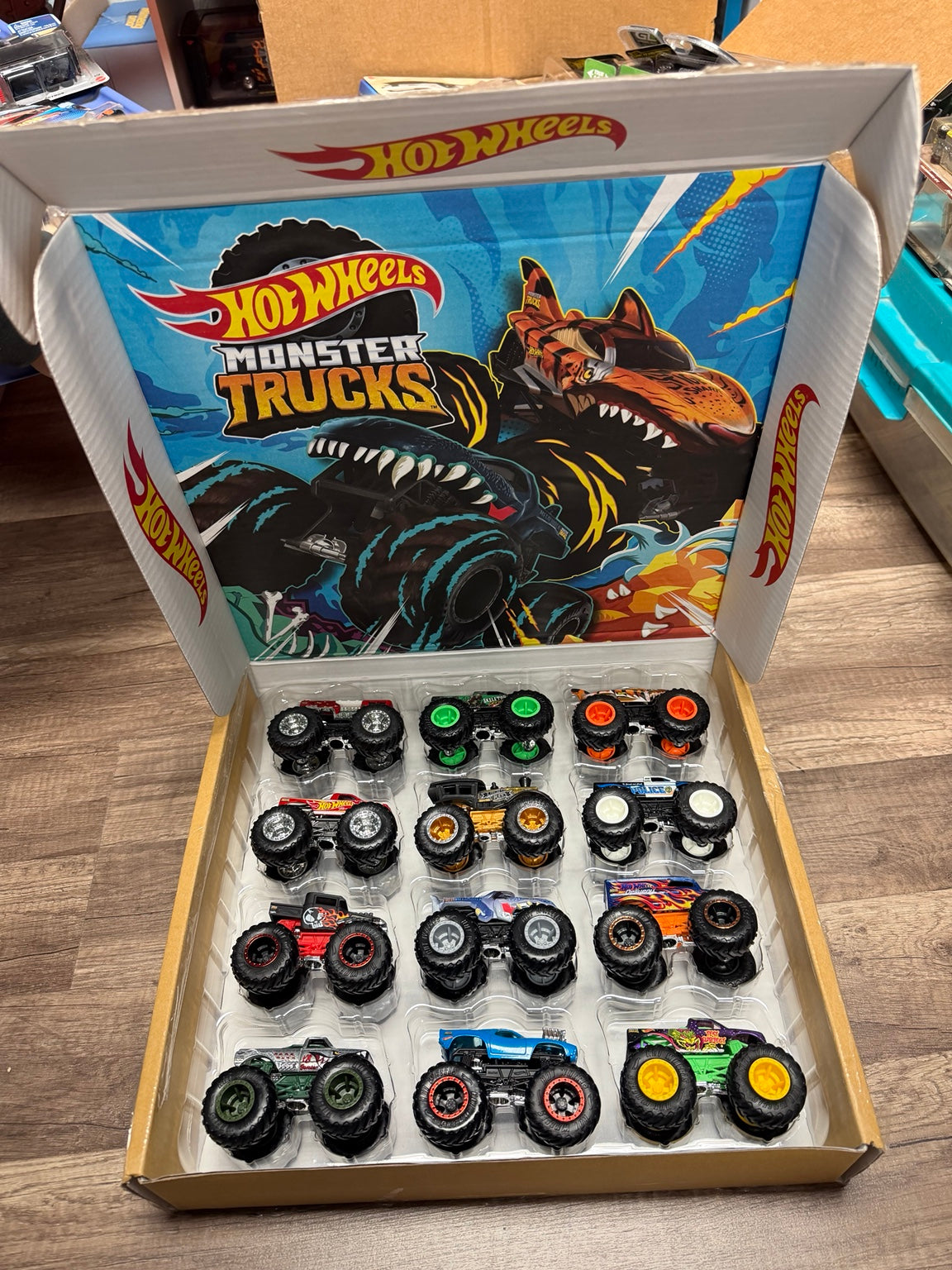 Original open display box with 12 Monster Trucks