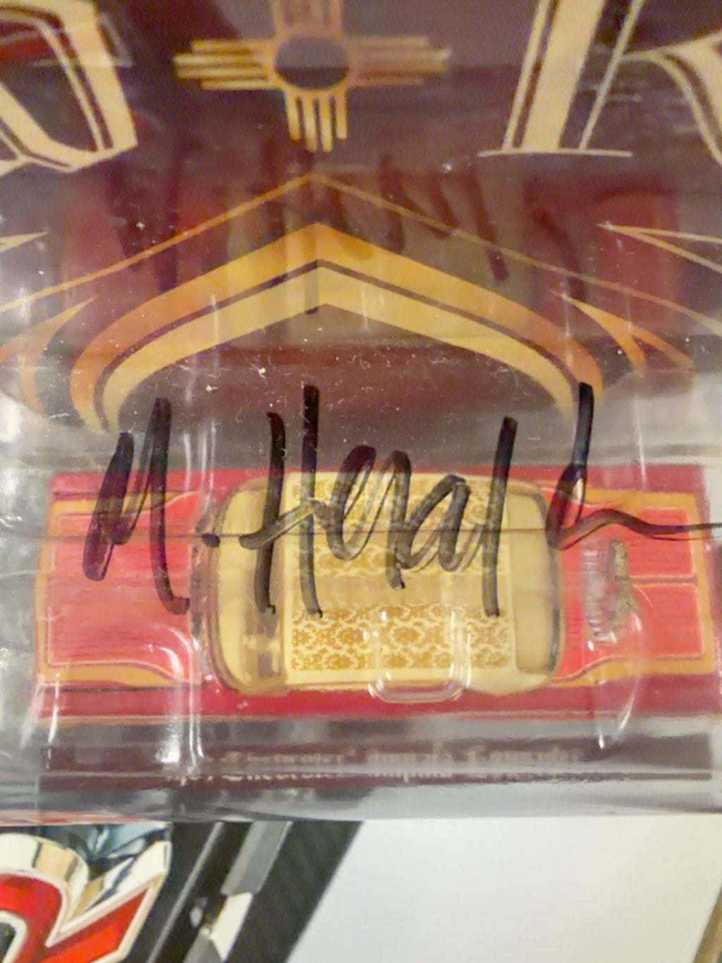 Close-up of Michael Heralda's hand-signed black Sharpie autograph on the blister