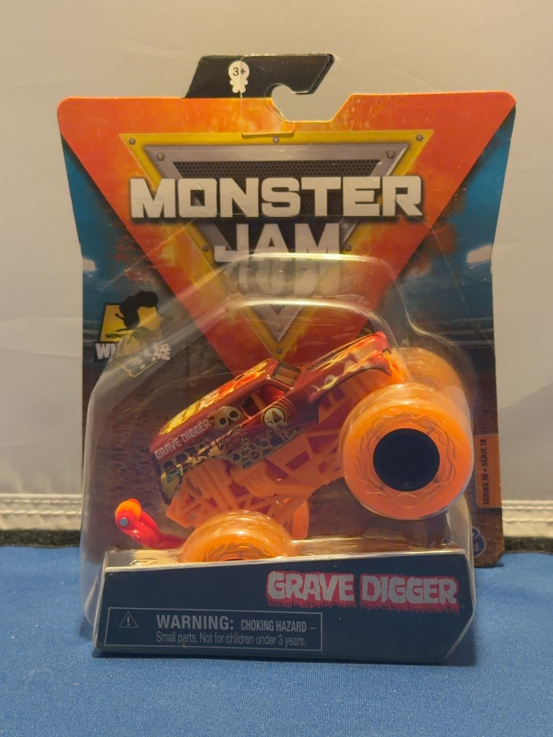 Monster Jam Series 18 Grave Digger Elementals Fire with translucent orange tires and wheelie bar, front